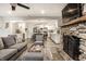 Open-concept living area features a stone fireplace, modern kitchen, and comfortable seating at 7082 Muskrat Dr, Nineveh, IN 46164