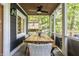 Screened-in porch offers wood table, seating, and views of the outdoors at 7082 Muskrat Dr, Nineveh, IN 46164