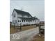A two-story home features white siding, black shutters, and a gravel driveway, surrounded by a yard at 756 S State Road 13, Lapel, IN 46051