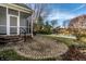 Backyard featuring a stone patio, scenic lake views, and mature trees at 8044 Clymer Ln, Indianapolis, IN 46250