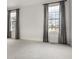 An empty bedroom has neutral carpet, two windows with curtains, and white walls at 8044 Clymer Ln, Indianapolis, IN 46250