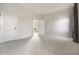 A bedroom with neutral carpet, two white doors, and a doorway to a room with natural lighting at 8044 Clymer Ln, Indianapolis, IN 46250