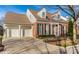 Traditional brick home with attached garage, black shutters and a paved driveway, offering curb appeal and convenience at 8044 Clymer Ln, Indianapolis, IN 46250