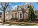 Beautiful brick home with black shutters, dormer windows and a lush green lawn, showcasing classic architectural details at 8044 Clymer Ln, Indianapolis, IN 46250