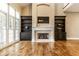Elegant fireplace with built-in shelves, hardwood floors, and a cozy ambiance for relaxing evenings at 8044 Clymer Ln, Indianapolis, IN 46250
