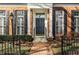 The house has a well landscaped brick walkway leading up to a black front door flanked by black shutters and columns at 8044 Clymer Ln, Indianapolis, IN 46250