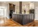 An open kitchen features a large center island with dark wood cabinetry and hardwood floors at 8044 Clymer Ln, Indianapolis, IN 46250