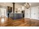 Spacious kitchen featuring a center island, stainless steel appliances, chandelier, and hardwood flooring at 8044 Clymer Ln, Indianapolis, IN 46250
