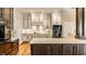 Open concept kitchen with white and dark wood cabinets, marble counters, and stainless appliances at 8044 Clymer Ln, Indianapolis, IN 46250