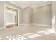 Sunlit living room showcasing neutral carpet, recessed lighting, and an open layout leading to a chandeliered room at 8044 Clymer Ln, Indianapolis, IN 46250
