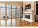 Bright living room features large windows, hardwood floors, a fireplace, and custom built-in shelving at 8044 Clymer Ln, Indianapolis, IN 46250