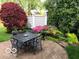 Outdoor dining and seating area on a brick patio surrounded by lush landscaping at 8044 Clymer Ln, Indianapolis, IN 46250