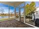 Enclosed sunroom with brick flooring and panoramic views of the landscaped backyard and water feature at 8044 Clymer Ln, Indianapolis, IN 46250
