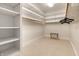 Spacious walk-in closet with custom shelving, hanging rods, and a convenient luggage rack at 8044 Clymer Ln, Indianapolis, IN 46250