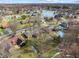 Expansive aerial view of a neighborhood featuring a pond and homes with backyard pools at 8316 Hill Gail Dr, Indianapolis, IN 46217