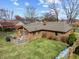 An aerial view of the beautiful brick home featuring a backyard deck and spacious yard at 8316 Hill Gail Dr, Indianapolis, IN 46217