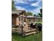 A backyard deck featuring an umbrella and chairs set up for relaxing and grilling at 8316 Hill Gail Dr, Indianapolis, IN 46217