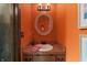 Bright powder room featuring oval mirror, updated vanity, and decorative lighting at 8316 Hill Gail Dr, Indianapolis, IN 46217