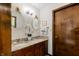 Bathroom features a double sink vanity with granite countertop, decorative mirrors and sconce lighting at 8316 Hill Gail Dr, Indianapolis, IN 46217