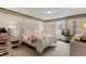 Bright, serene bedroom with a large white headboard, floral bedding, and a window offering natural light at 8316 Hill Gail Dr, Indianapolis, IN 46217