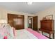 Bedroom with pink accent blanket on bed and wooden desk. Features a closet and adjoining room at 8316 Hill Gail Dr, Indianapolis, IN 46217