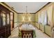 Traditional dining room with chandelier, elegant table setting, and large windows offering ample natural light at 8316 Hill Gail Dr, Indianapolis, IN 46217