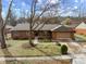 Charming brick home with well-maintained landscaping, mature trees, and a two-car garage at 8316 Hill Gail Dr, Indianapolis, IN 46217