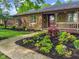 Charming brick home featuring a beautifully landscaped front yard and welcoming entrance at 8316 Hill Gail Dr, Indianapolis, IN 46217