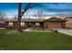 Charming brick ranch home featuring an attached garage, front porch, and a well-maintained lawn and mature tree at 8316 Hill Gail Dr, Indianapolis, IN 46217