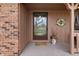 Cozy front porch featuring a decorative door, potted plants, and a wreath, enhancing curb appeal at 8316 Hill Gail Dr, Indianapolis, IN 46217