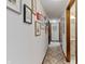 Hallway with white walls, neutral patterned carpet and several framed photos at 8316 Hill Gail Dr, Indianapolis, IN 46217