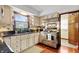 Well-lit kitchen with stainless steel appliances, black countertops, and a view of the backyard from the window at 8316 Hill Gail Dr, Indianapolis, IN 46217