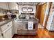 Updated kitchen with stainless steel oven and range, with patterned backsplash and an eat-in area at 8316 Hill Gail Dr, Indianapolis, IN 46217