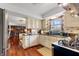 Well-maintained kitchen featuring wood floors, white cabinets, stainless steel appliances, and natural light at 8316 Hill Gail Dr, Indianapolis, IN 46217