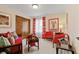 Living room features colorful curtains and furniture, wood paneled closet and neutral carpet at 8316 Hill Gail Dr, Indianapolis, IN 46217