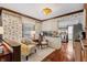 Cozy sitting area and kitchen featuring wood floors, vintage wallpaper, and plenty of natural light at 8316 Hill Gail Dr, Indianapolis, IN 46217