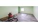 Newly floored basement area, showcasing light gray vinyl flooring with a Craftsman vacuum and tools at 8350 E Cr 200 S, Zionsville, IN 46077