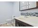 Bathroom featuring a vanity with mosaic backsplash, toilet, and mirror at 8350 E Cr 200 S, Zionsville, IN 46077