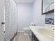 Bathroom with patterned shower curtain, toilet, vanity and backsplash at 8350 E Cr 200 S, Zionsville, IN 46077