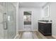Bathroom featuring a glass shower and a dark vanity with stone countertops at 8350 E Cr 200 S, Zionsville, IN 46077