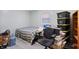 Bedroom with carpet, light blue walls, one window, black chair, and dark wood bookcase at 8350 E Cr 200 S, Zionsville, IN 46077