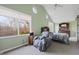 Bedroom with carpet, vaulted ceiling, sitting chair, and a large window looking out to trees at 8350 E Cr 200 S, Zionsville, IN 46077