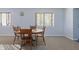 Bright dining area featuring a wooden table with chairs, neutral carpet, and windows with blinds for natural light at 8350 E Cr 200 S, Zionsville, IN 46077