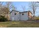 Two-story home featuring light-blue siding, multiple windows, and a walk-out basement, set in a wooded area at 8350 E Cr 200 S, Zionsville, IN 46077