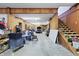 Inside a large garage showcasing ample space, wooden paneling, and a staircase to a loft area at 8350 E Cr 200 S, Zionsville, IN 46077