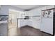 Well-lit kitchen with white cabinets, modern appliances, and a view into the dining area at 8350 E Cr 200 S, Zionsville, IN 46077