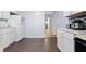 Well-lit kitchen features white cabinets, stainless steel appliances, marble countertops, and wood floors at 8350 E Cr 200 S, Zionsville, IN 46077