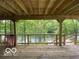 Spacious wooden deck with views of the lake surrounded by trees at 8381 S Kinman Dr, , IN 46164