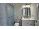 Modern bathroom with glass door shower, white vanity, and light fixtures at 104 Walnut Ct, Noblesville, IN 46062