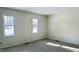 Sunny bedroom features two windows, carpet, and neutral walls at 104 Walnut Ct, Noblesville, IN 46062